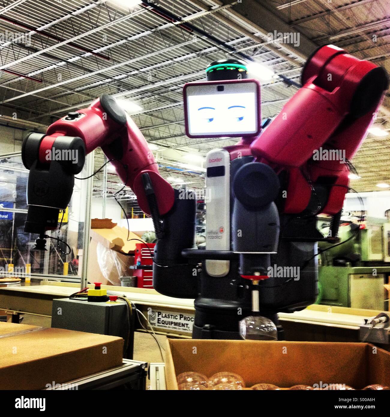 A Baxter robot made by Rethink Robotics in a factory setting. Stock Photo