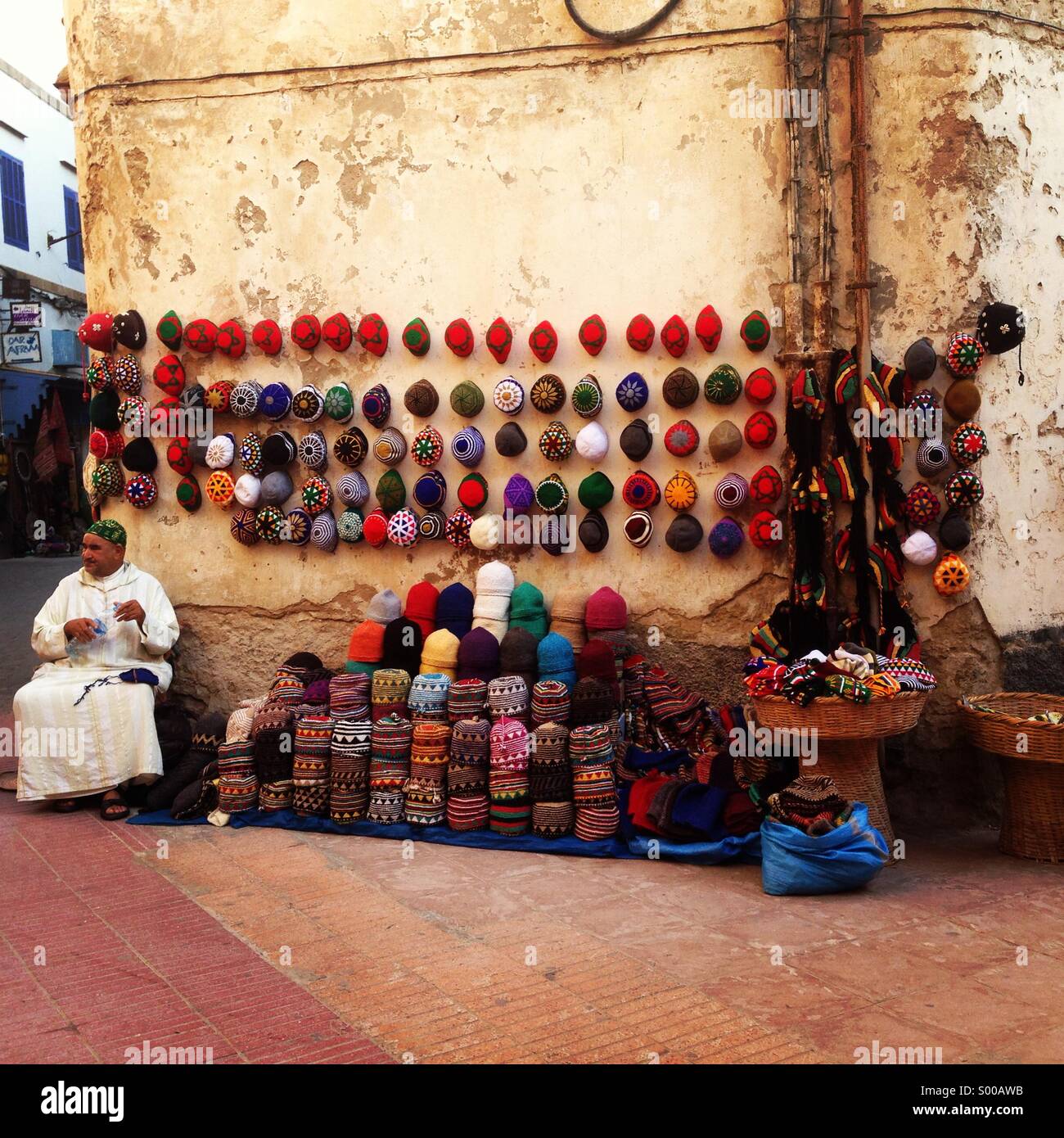 A seller trading with artisanal products for sale to tourists, Essaouira, Marocco, Africa - Smartphone Captured Stock Image