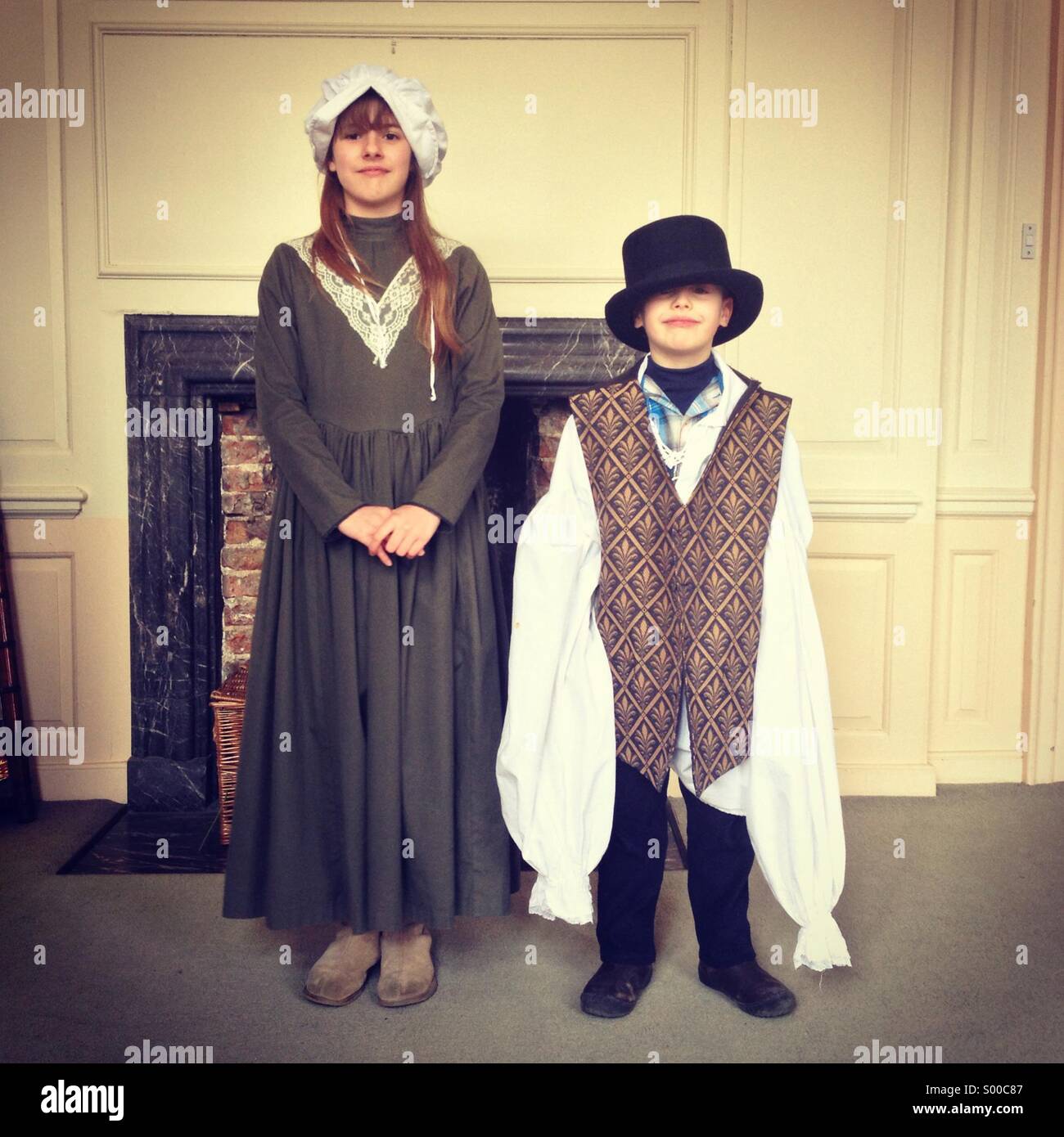 Brother and sister dressing up in old fashioned clothes Stock Photo
