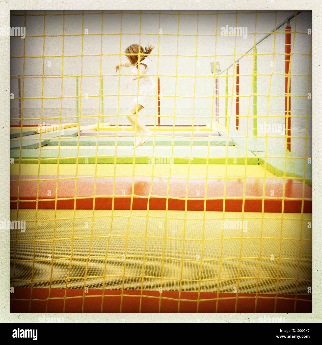 Girl Jumping on Trampoline Stock Photo