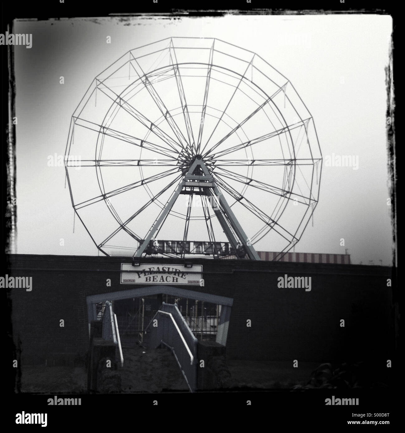 The Ferris wheels at Skegness, England on a misty day. Stock Photo
