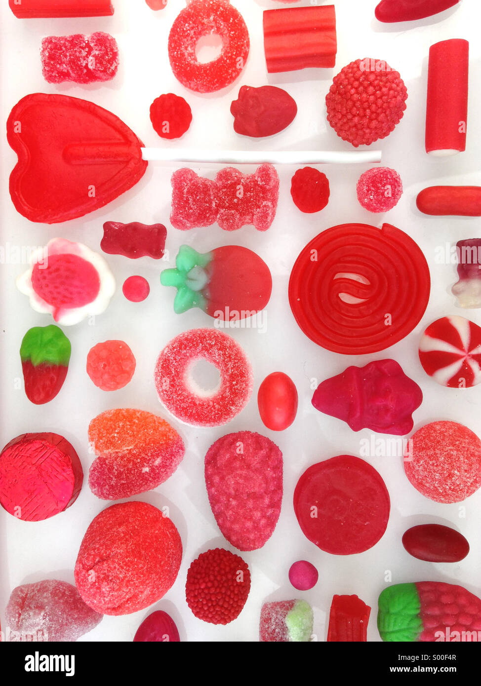 Assotted selection of red sweets and candies. Stock Photo