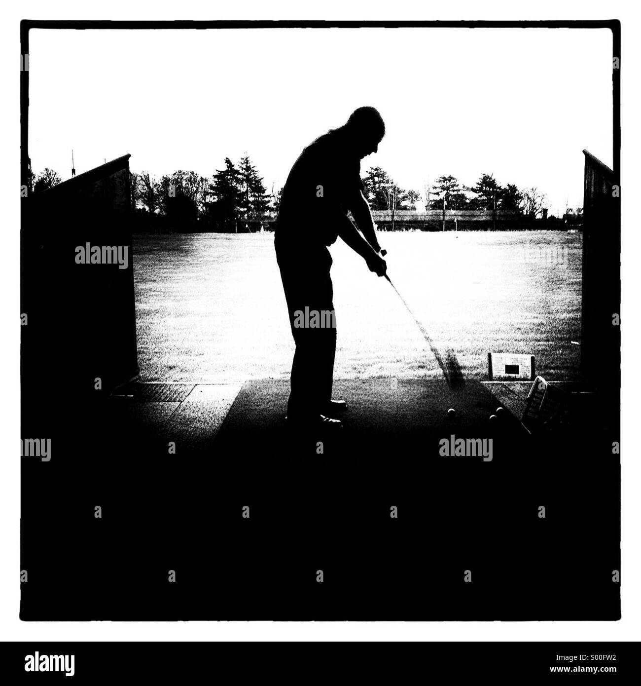 Golfer practising golf at driving  range - Smartphone Captured Stock Image