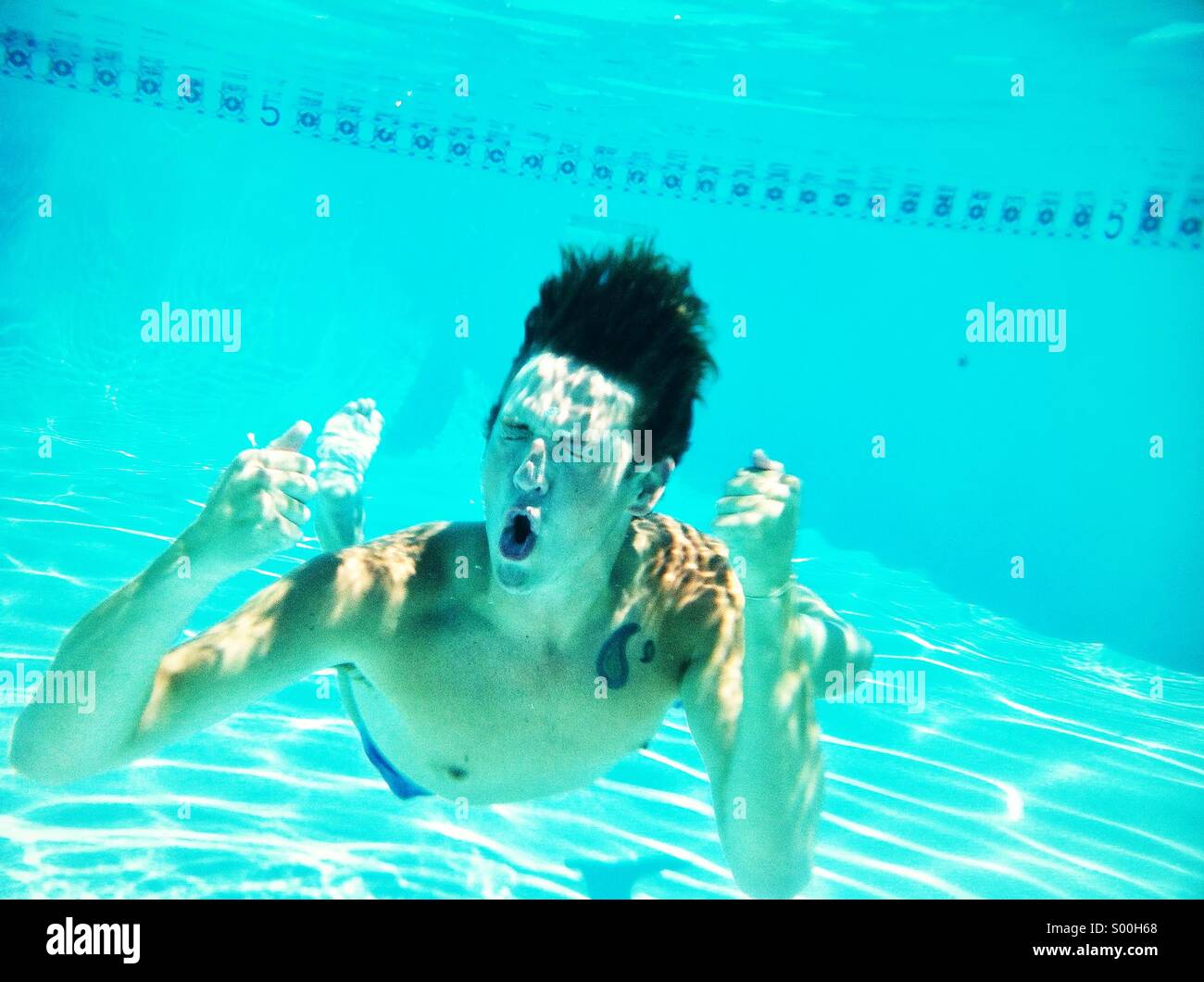 Ecstatic man underwater Stock Photo