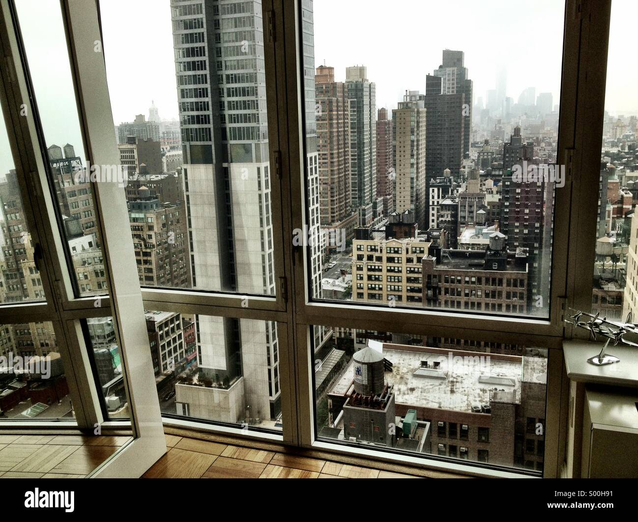 View of lower Manhattan out the window of a luxury high-rise apartment in New York City Stock Photo