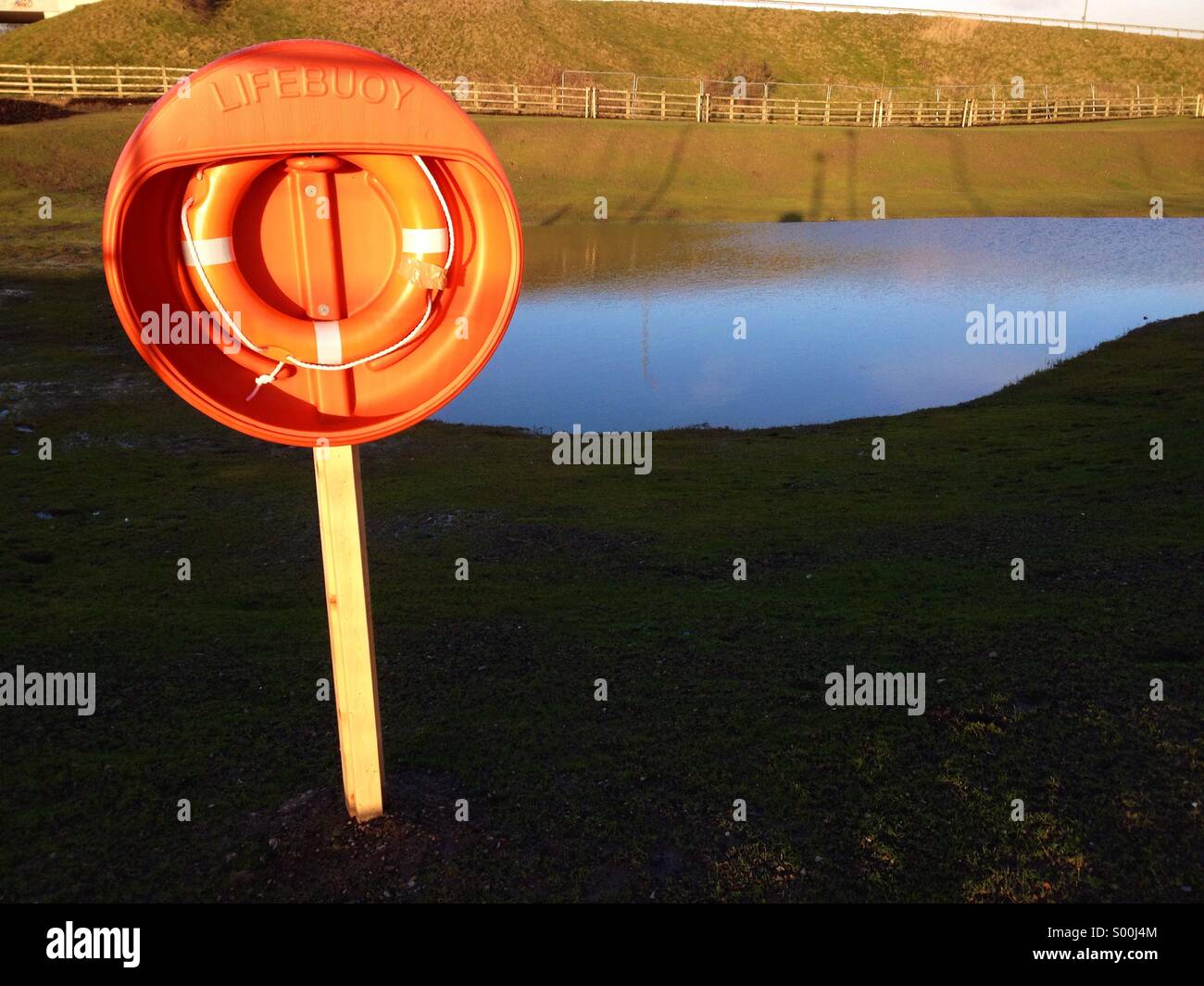 Orange life buoy by pool on Buckshaw village development in Chorley - Smartphone Captured Stock Image
