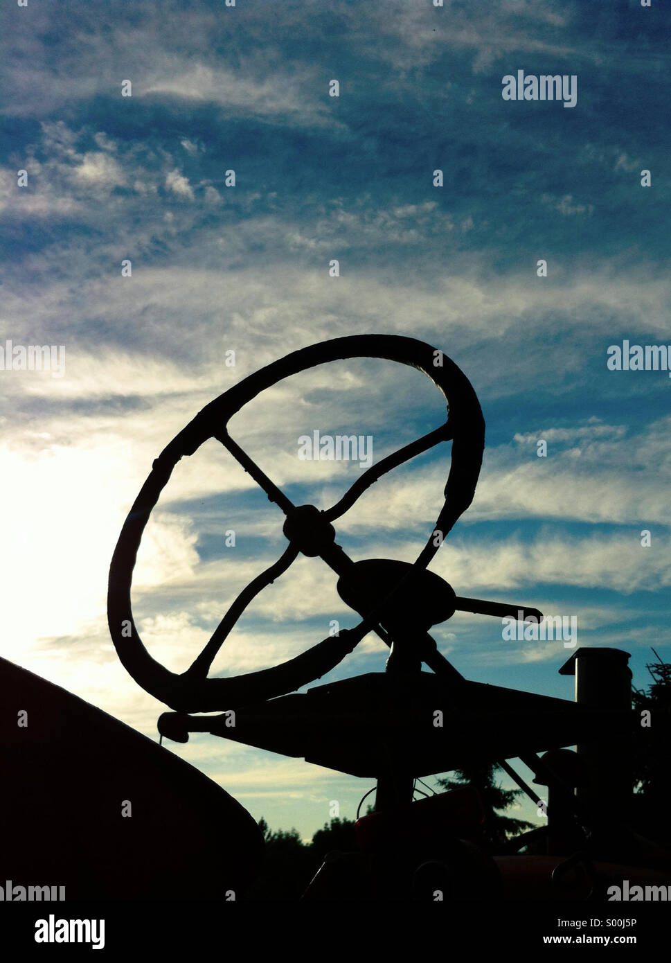 Tractor steering wheel silhouette. - Smartphone Captured Stock Image