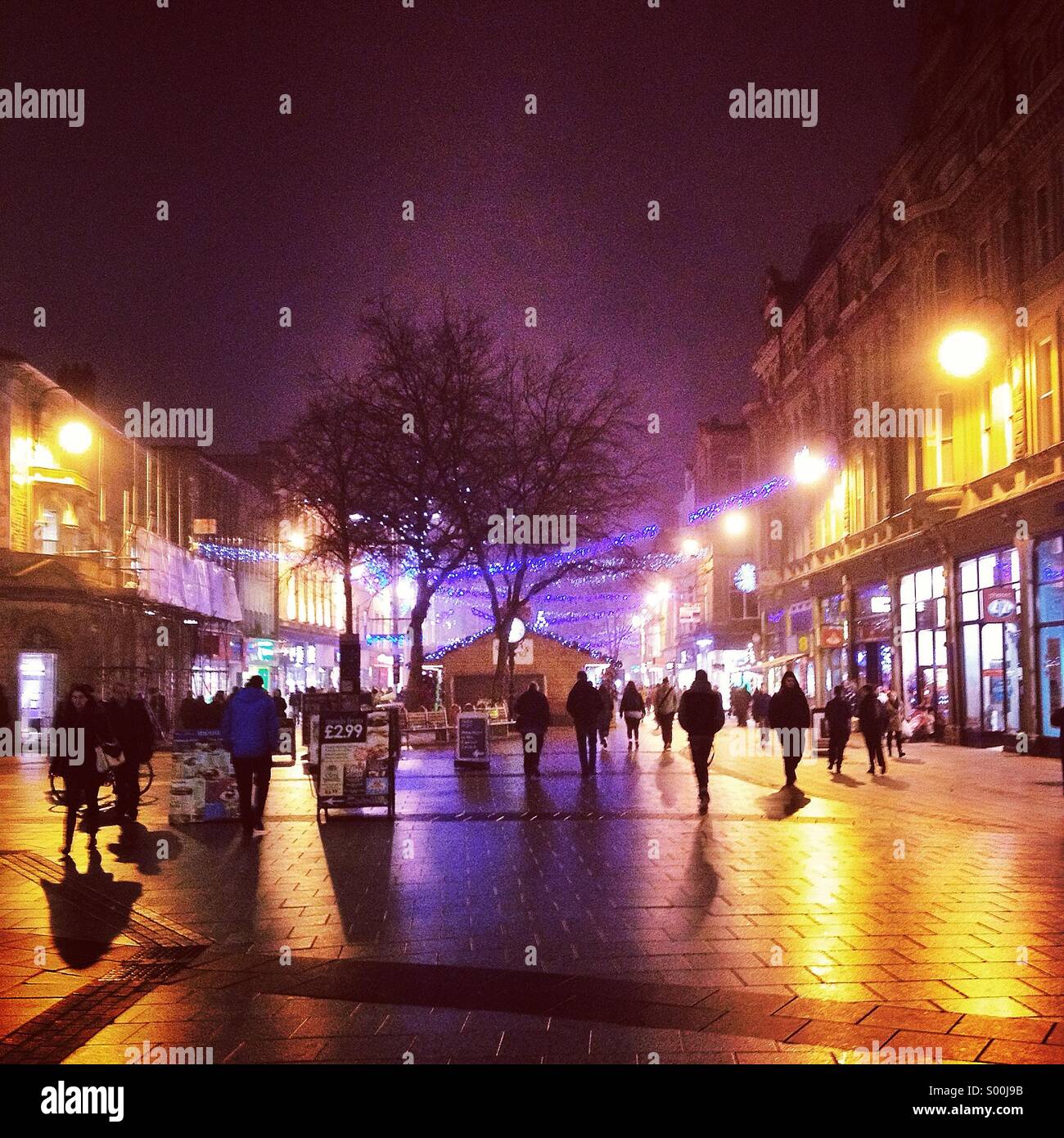 A busy Queen Street in Cardiff, at night Stock Photo Alamy
