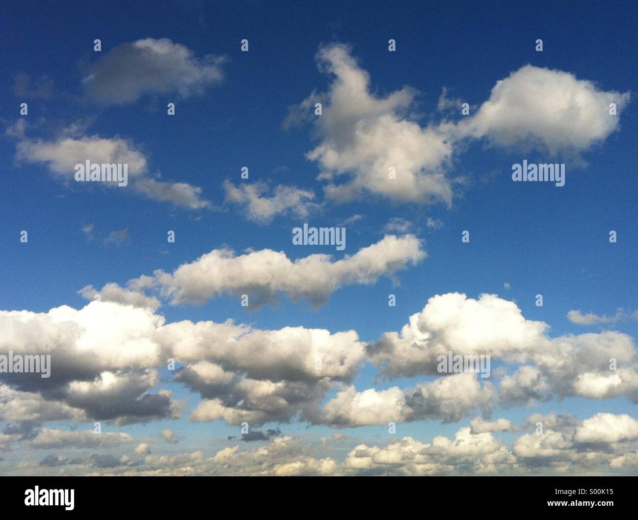 Blue sky with white fluffy clouds - Smartphone Captured Stock Image