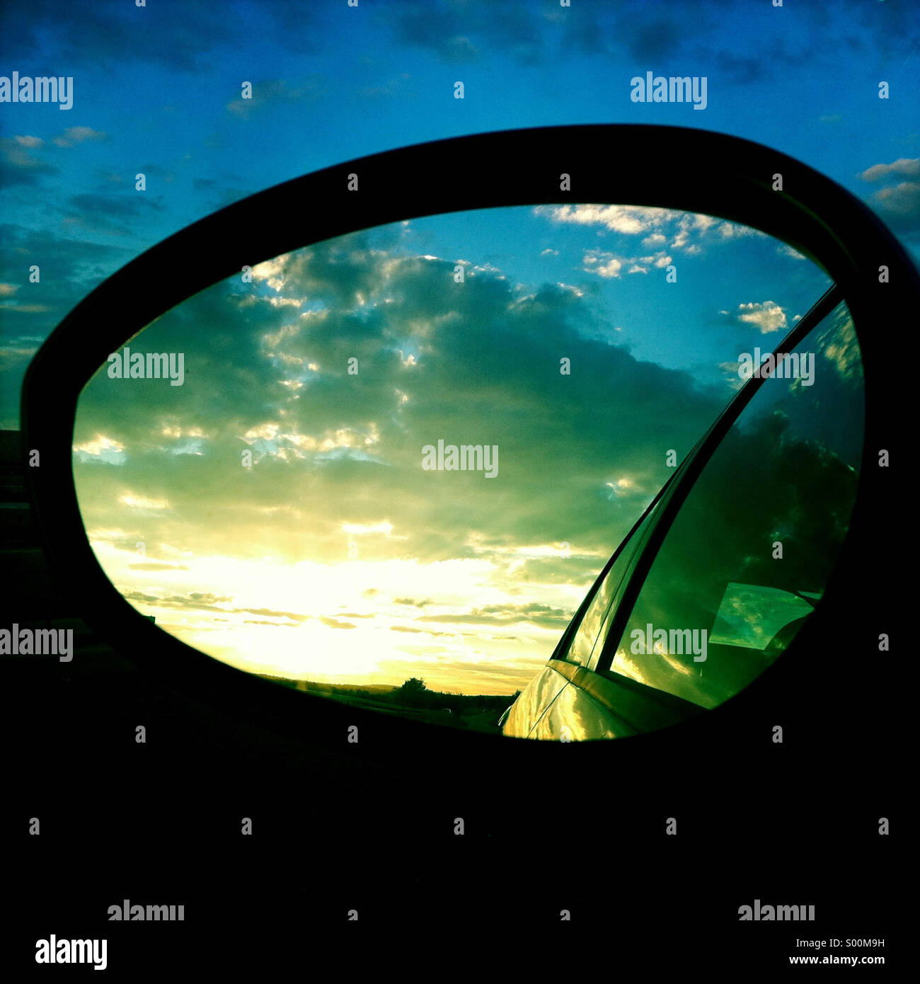 Travel - Reflection of beautiful sky in rear mirror of car - Smartphone Captured Stock Image