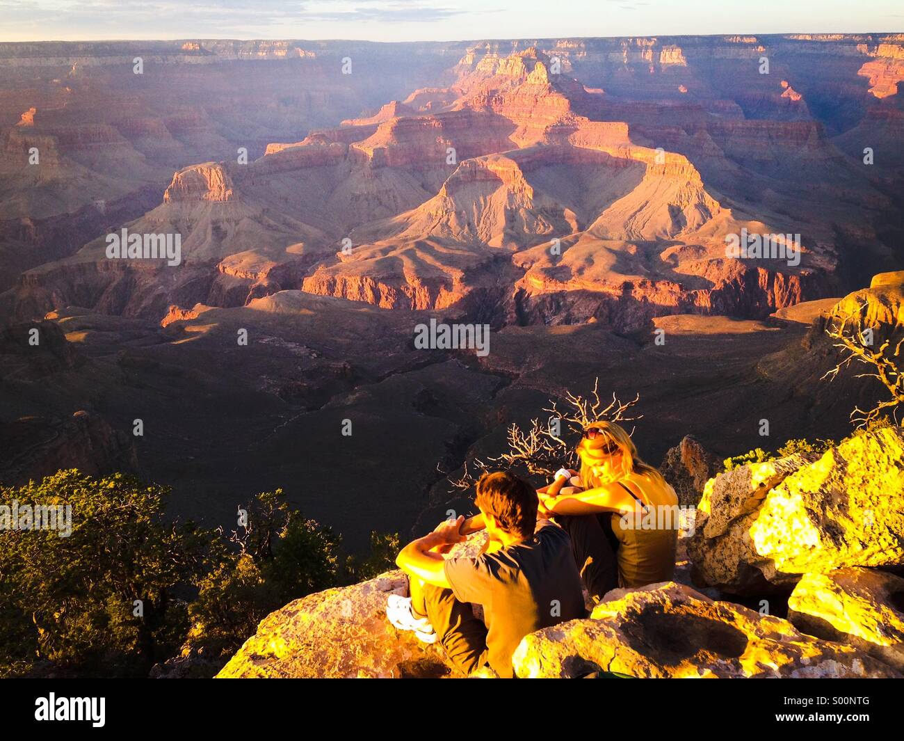 Young couple admiring the sunset,The Grand Canyon National Park,Arizona,USA - Smartphone Captured Stock Image