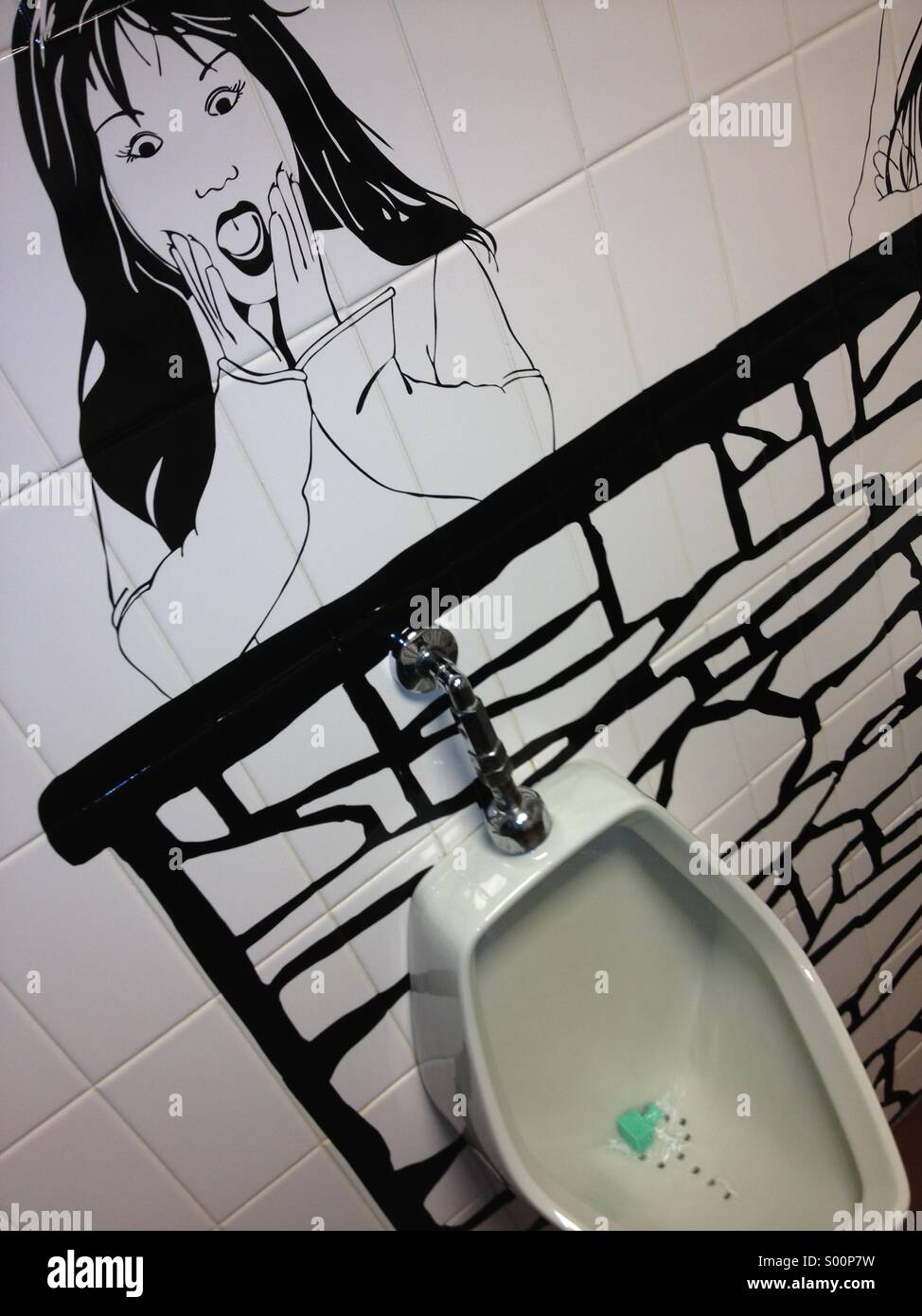 Sketch of young woman above urinal in a men's toilet, arranged to make fun of men's manhood. Stock Photo