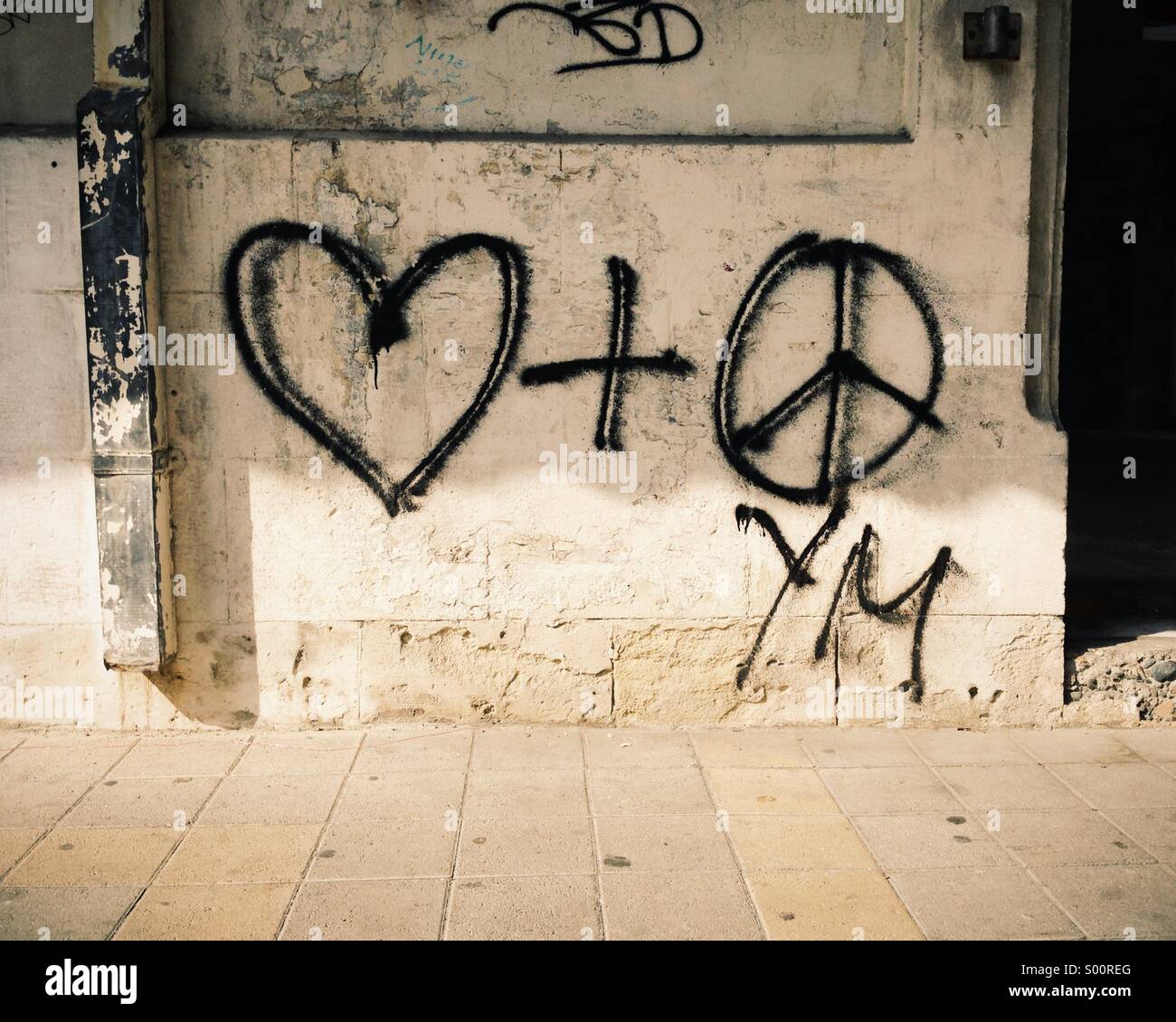Heart and peace symbols graffiti on a wall. Peace and love Stock Photo