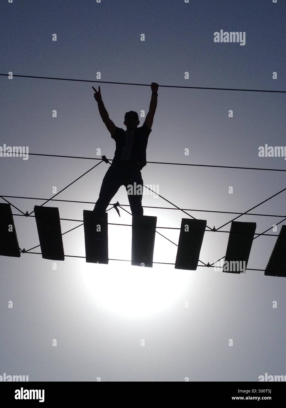Winner standing on a hanging ladder with a winning sign Stock Photo