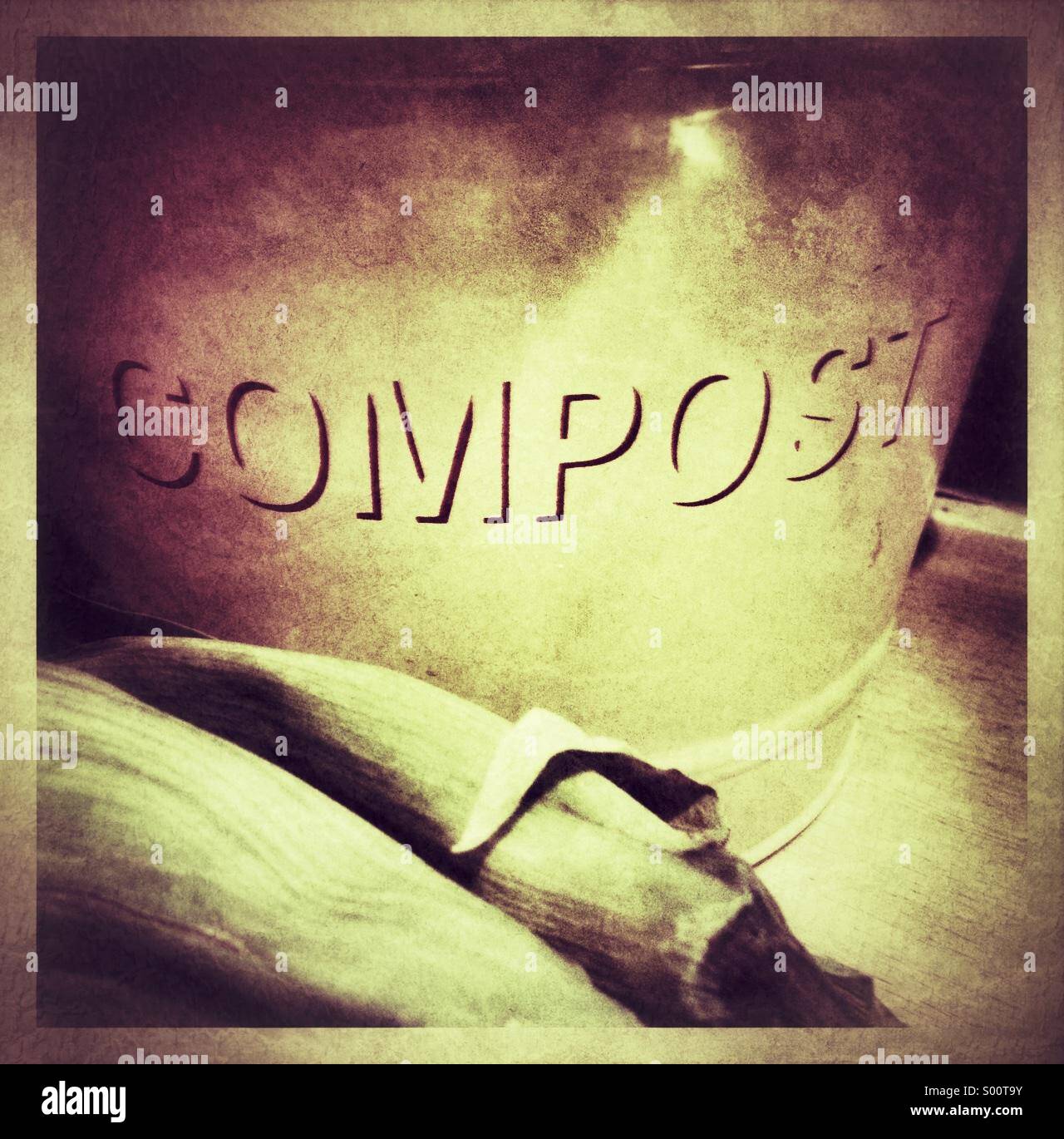 Grungy close up of compost bucket and two leeks. - Smartphone Captured Stock Image