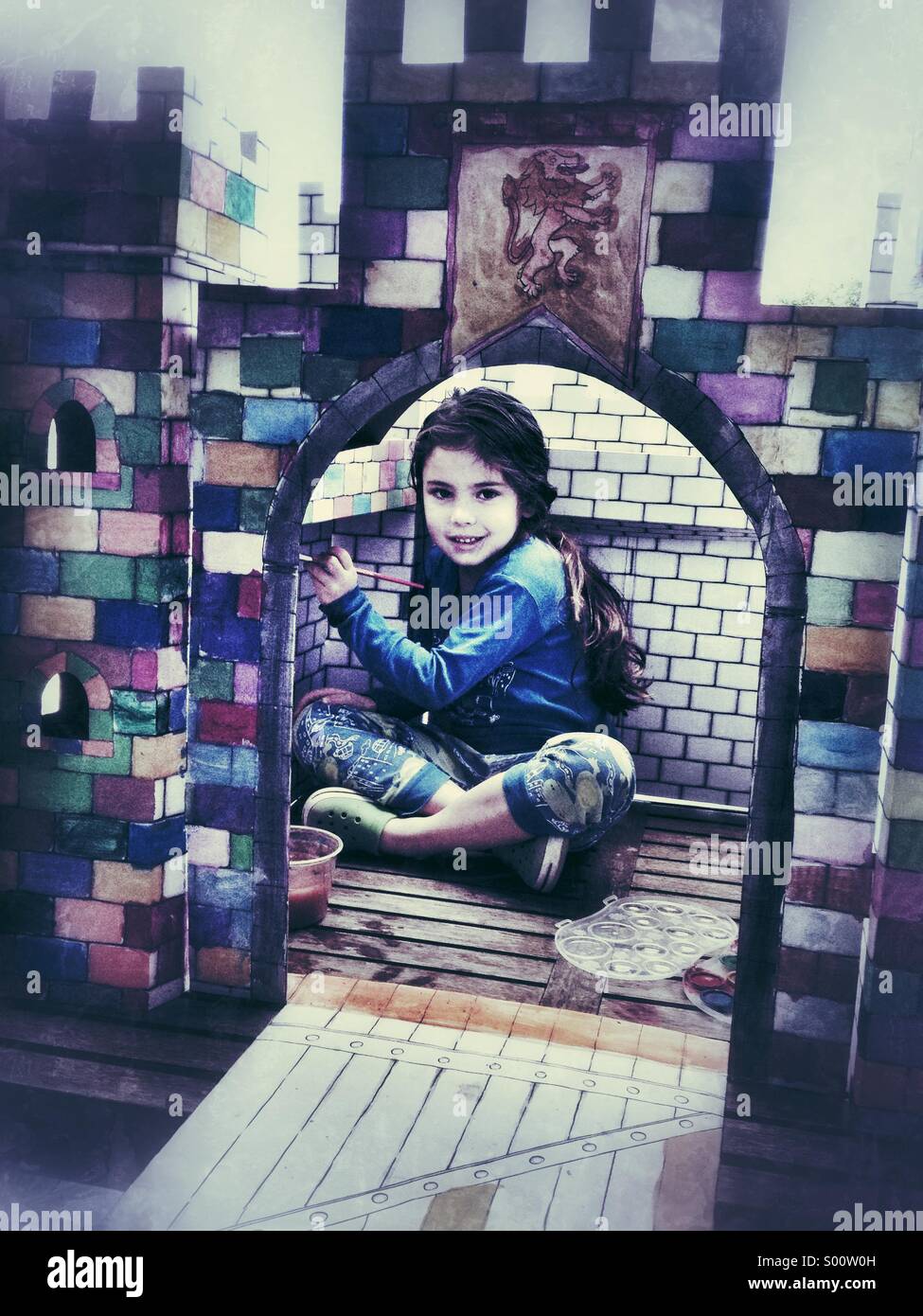 Girl in multicoloured carton castle - Smartphone Captured Stock Image