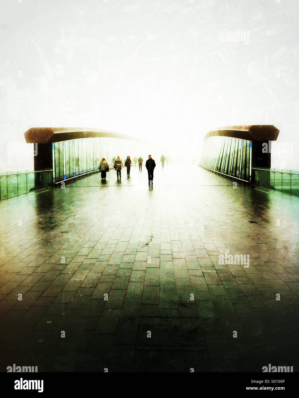 Walking across the bridge to Stratford from Stratford City on a foggy winter morning. - Smartphone Captured Stock Image