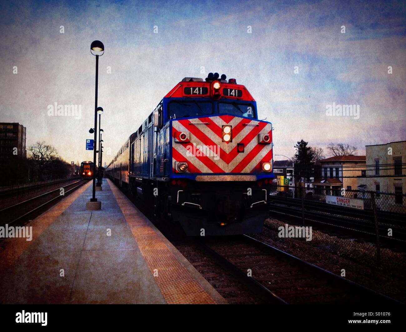 Metra commuter train pulling into Oak Park, Illinois station during evening rush hour. Stock Photo