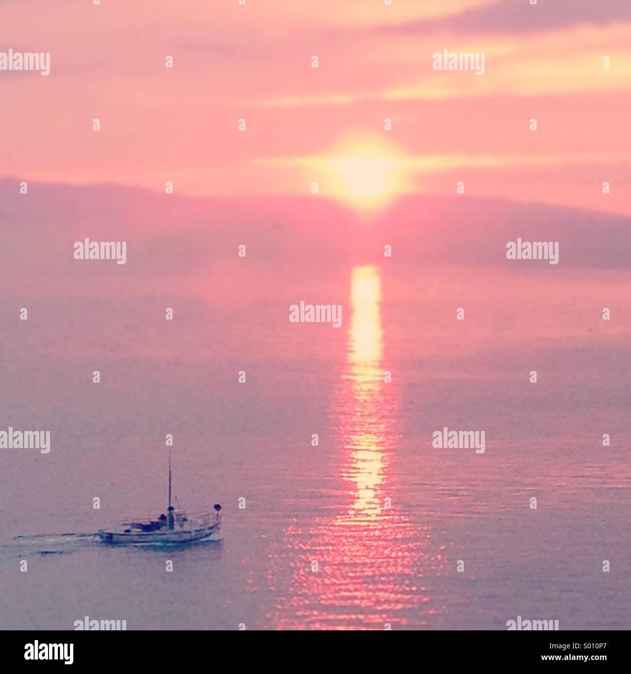 Fishing boat in sunset Stock Photo - Alamy