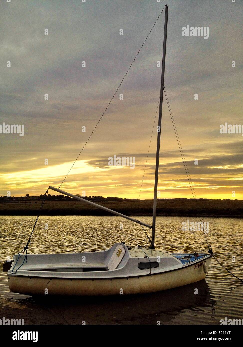 Moored boat at sunset Stock Photo