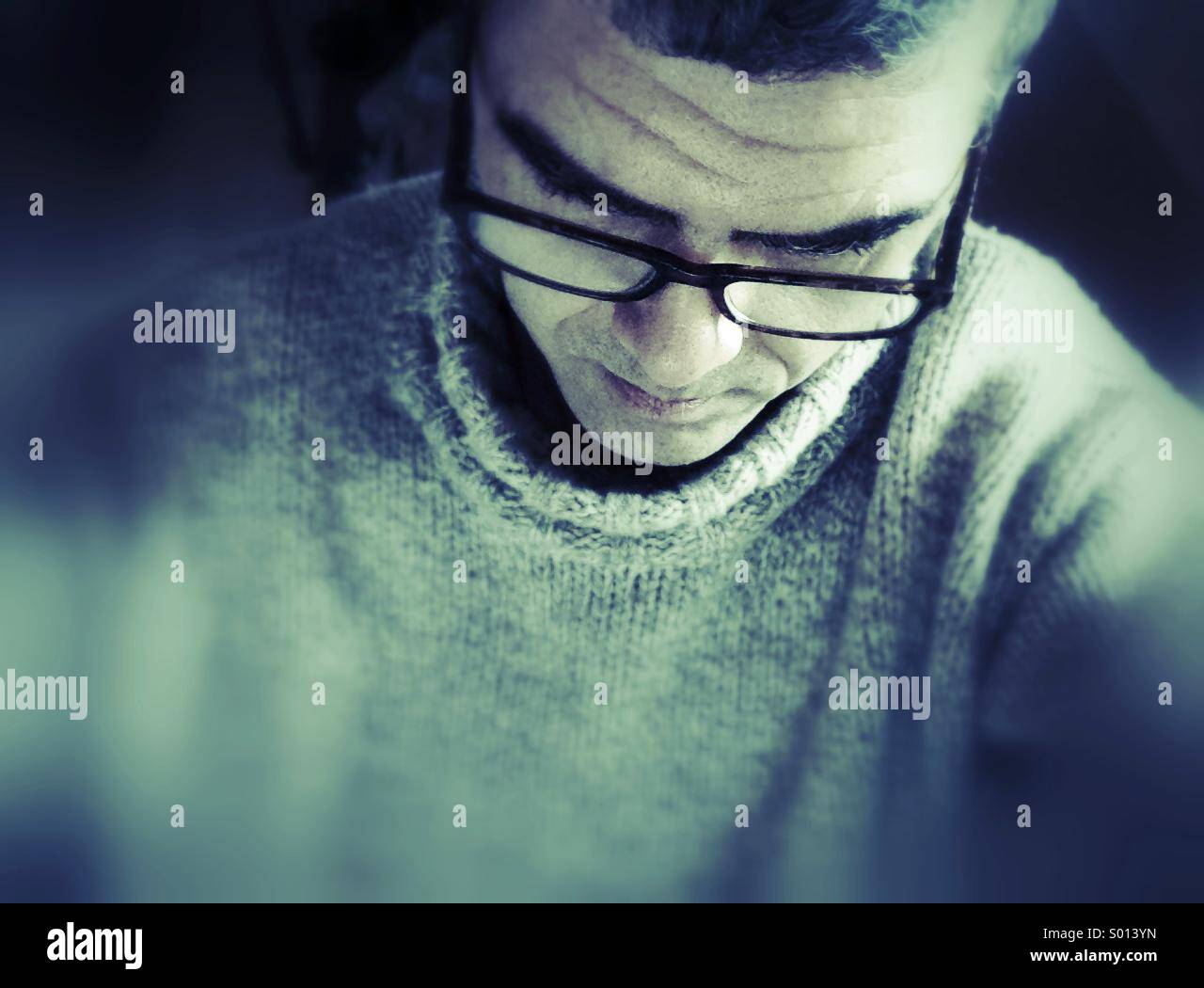 Man with glasses reading. - Smartphone Captured Stock Image