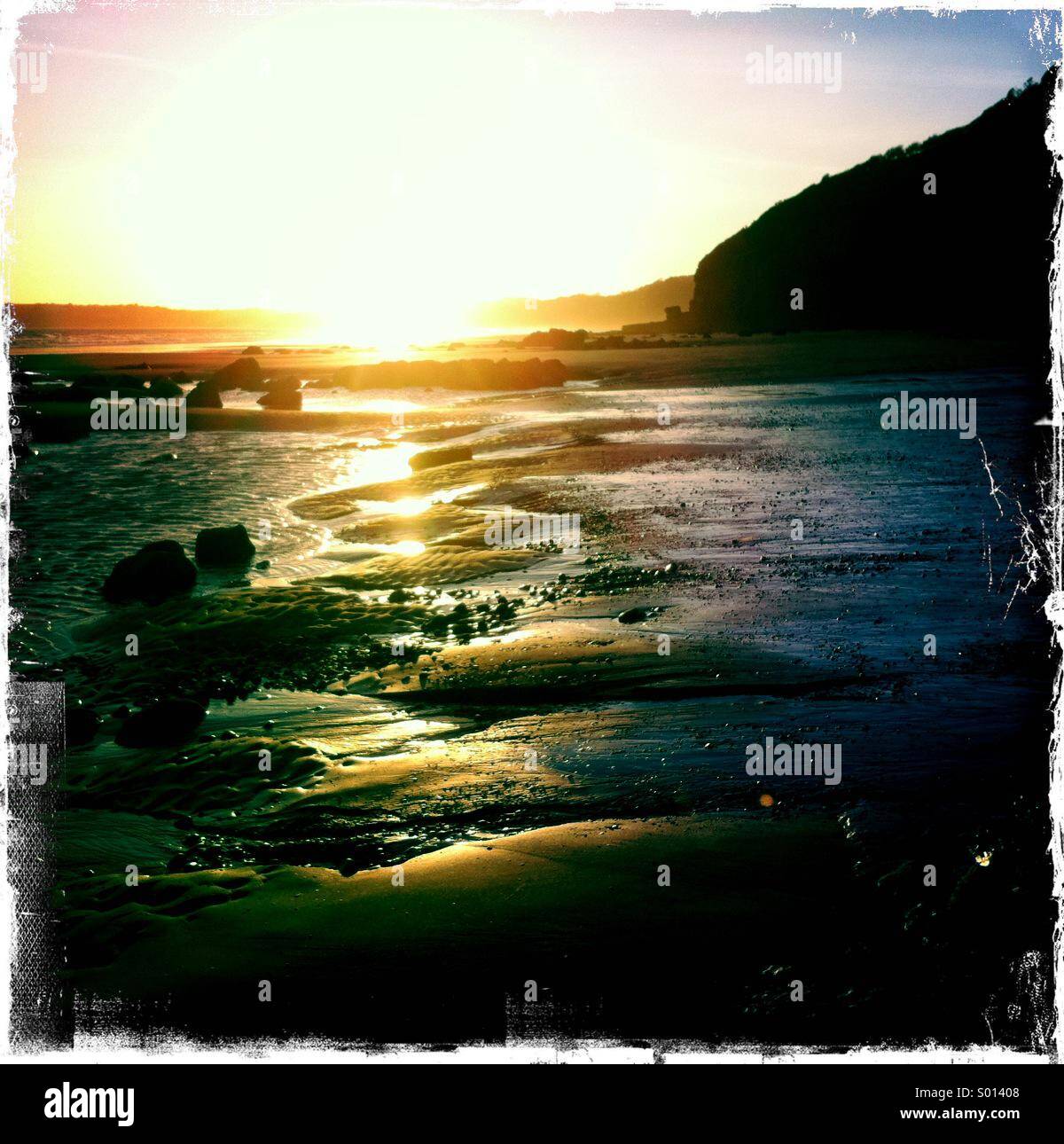 Beach scene at sunset Stock Photo Alamy