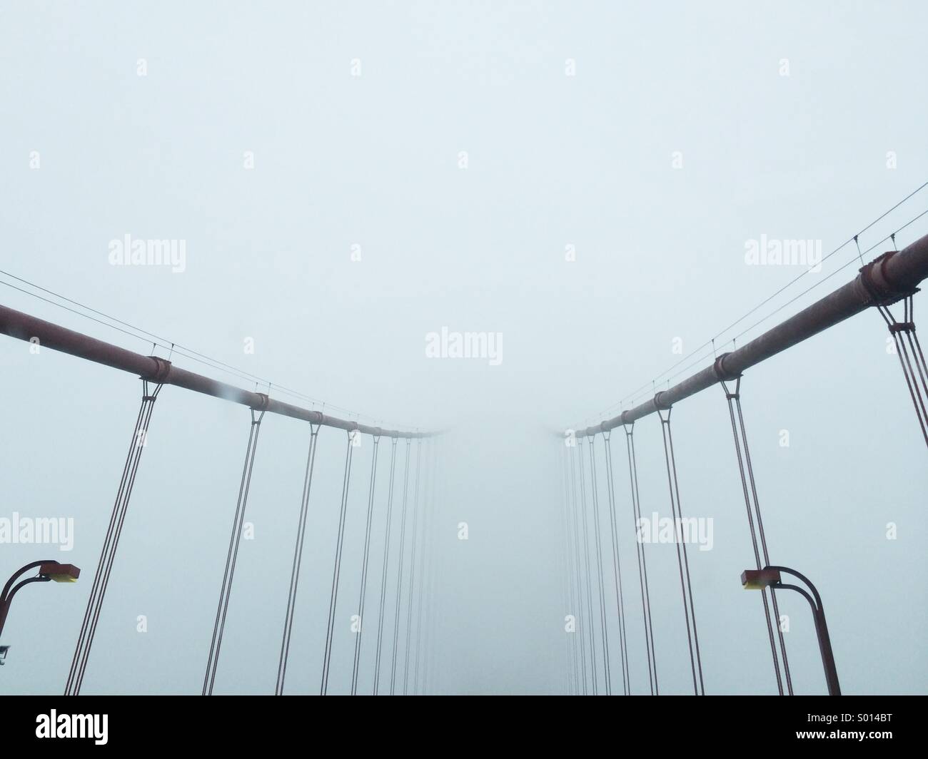 Golden Gate Bridge suspension cables disappearing into the fog Stock