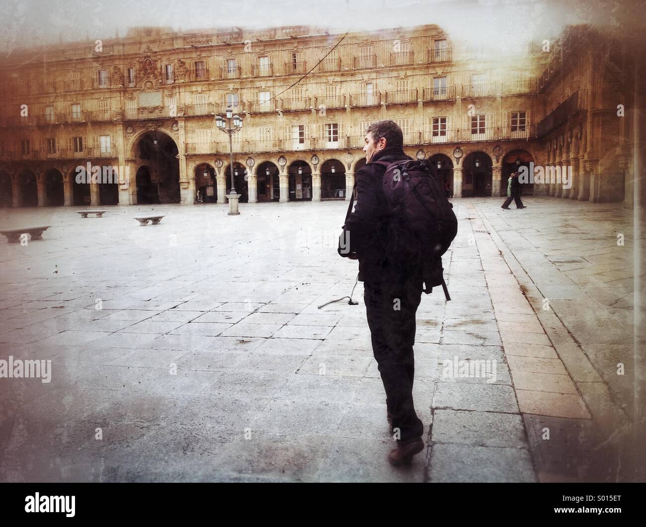 Man crosses Plaza mayor in Salamanca, Spain. - Smartphone Captured Stock Image