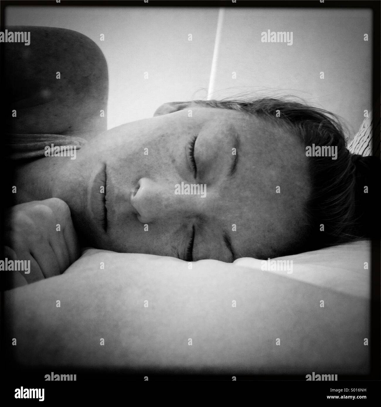 A black and white photo of a woman sleeping. - Smartphone Captured Stock Image