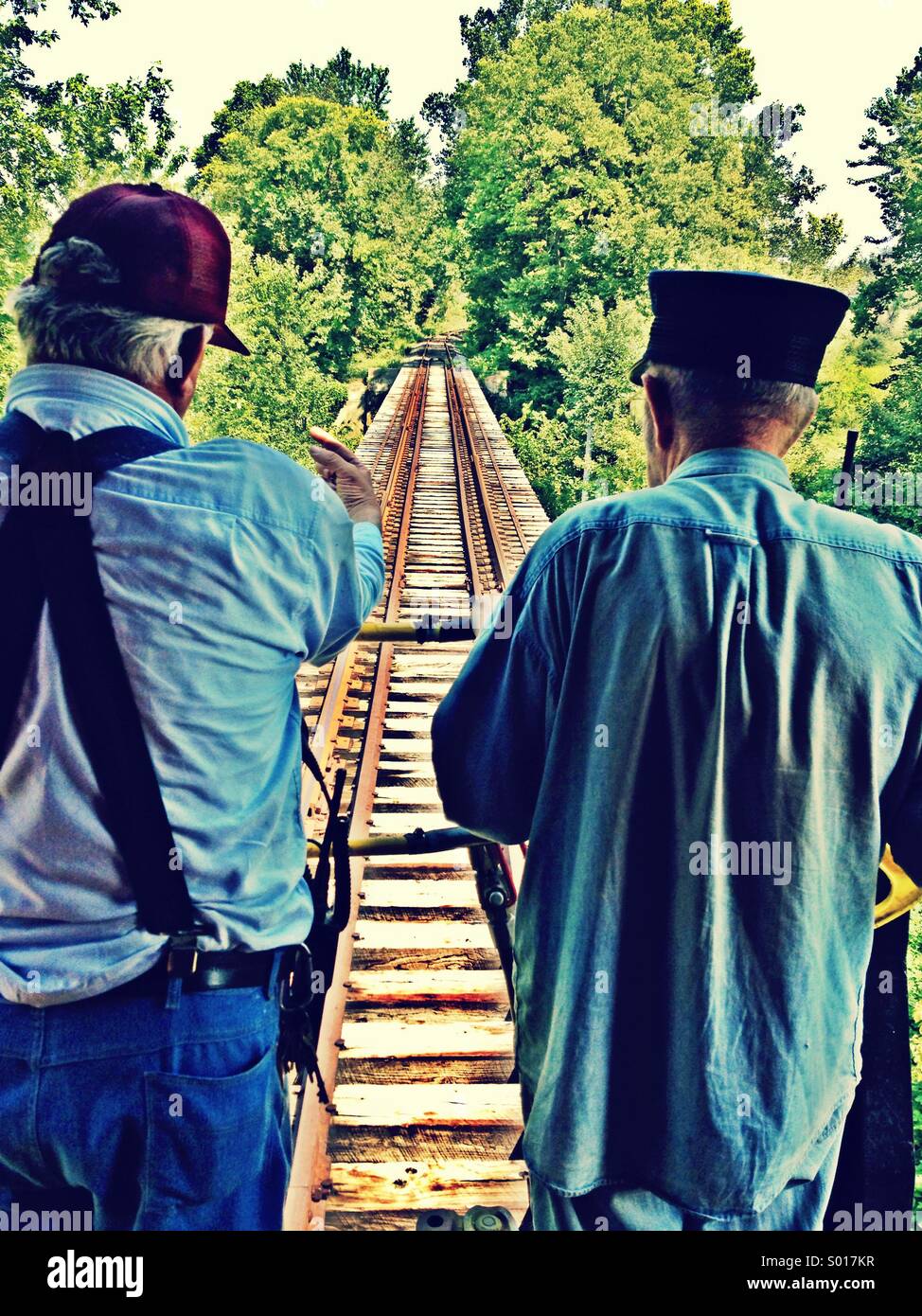 A brakeman and conductor peer off the caboose end of a train Stock Photo Alamy