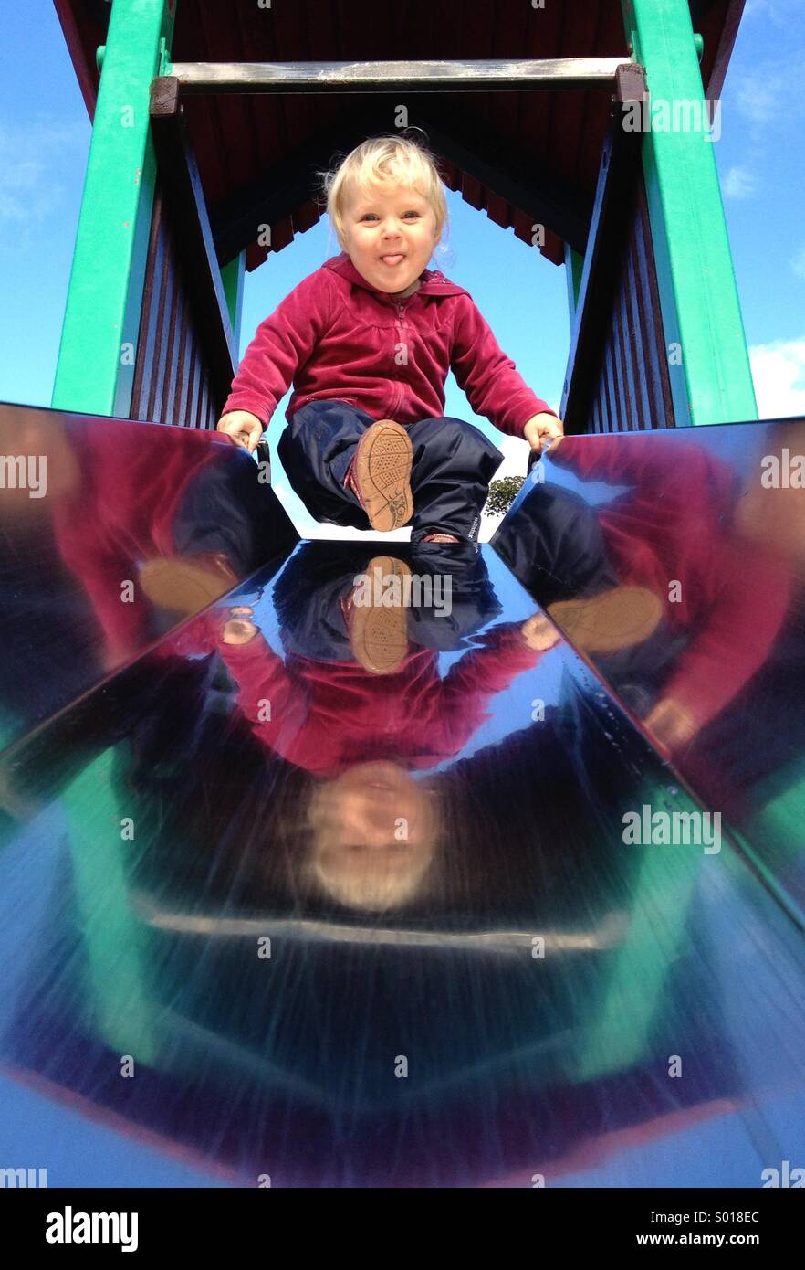 Child preparing to go down slide Stock Photo Alamy