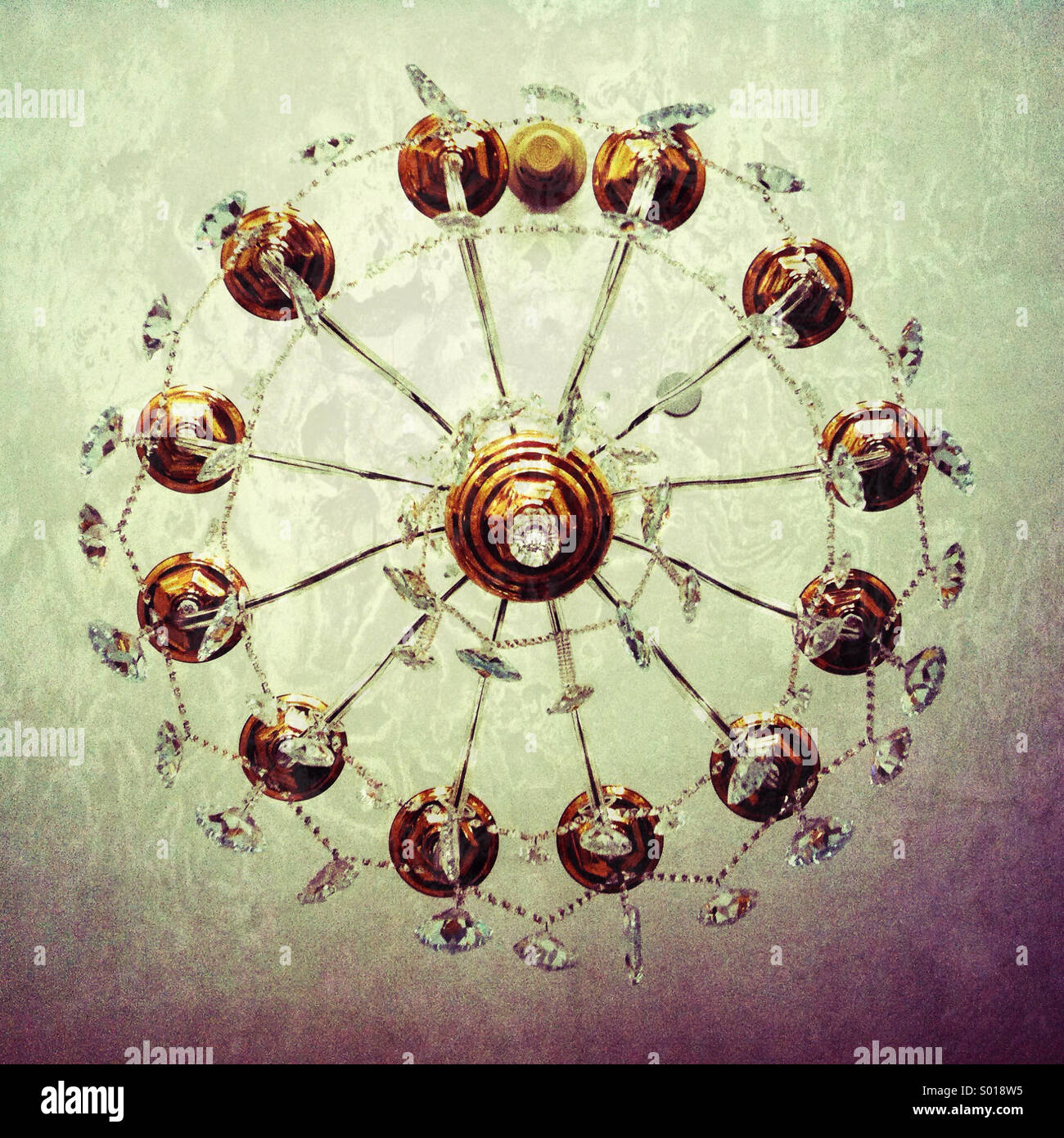 A view from below a fancy crystal and brass chandelier - Smartphone Captured Stock Image