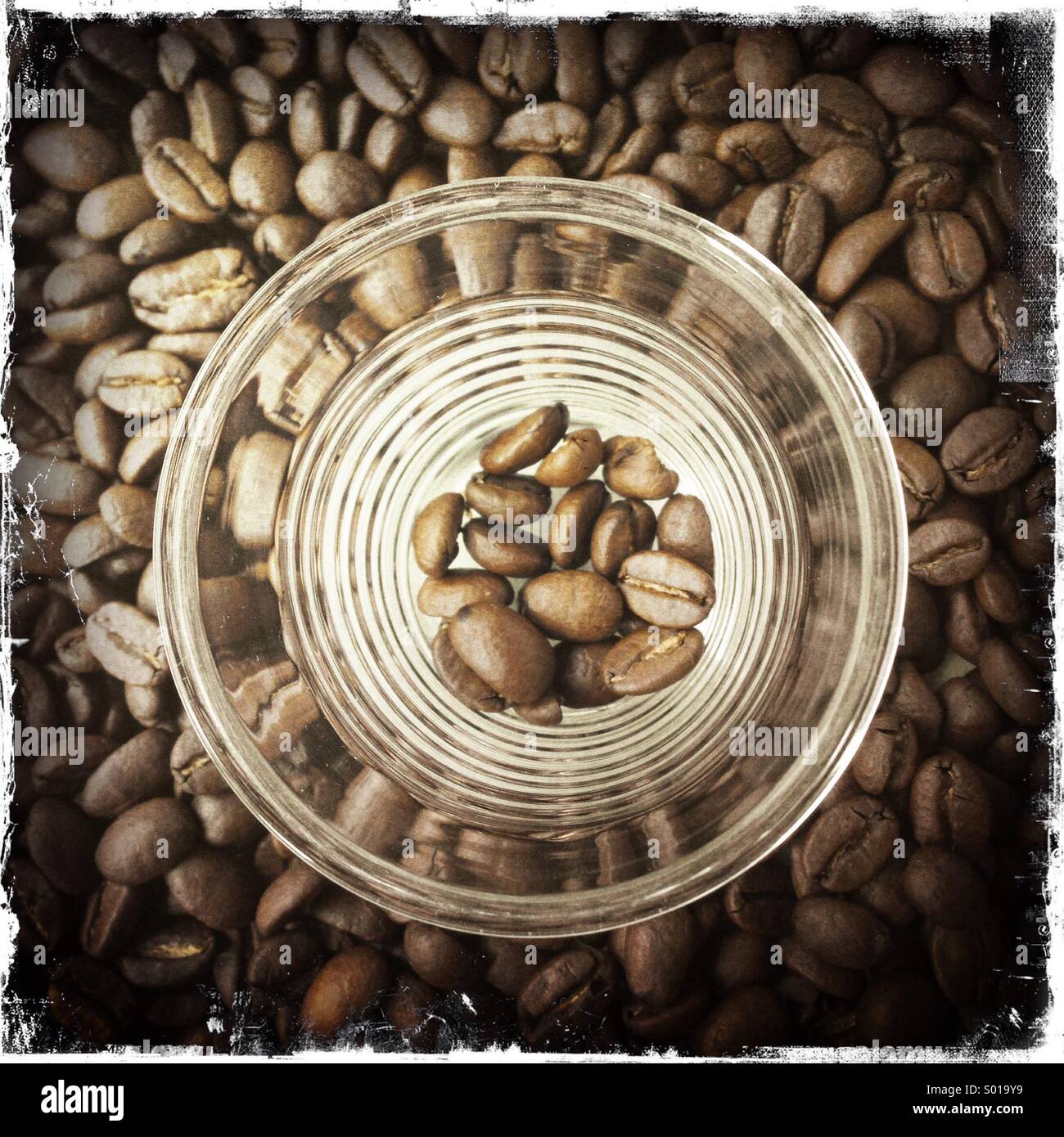 Glass espresso cup over coffee beans - Smartphone Captured Stock Image