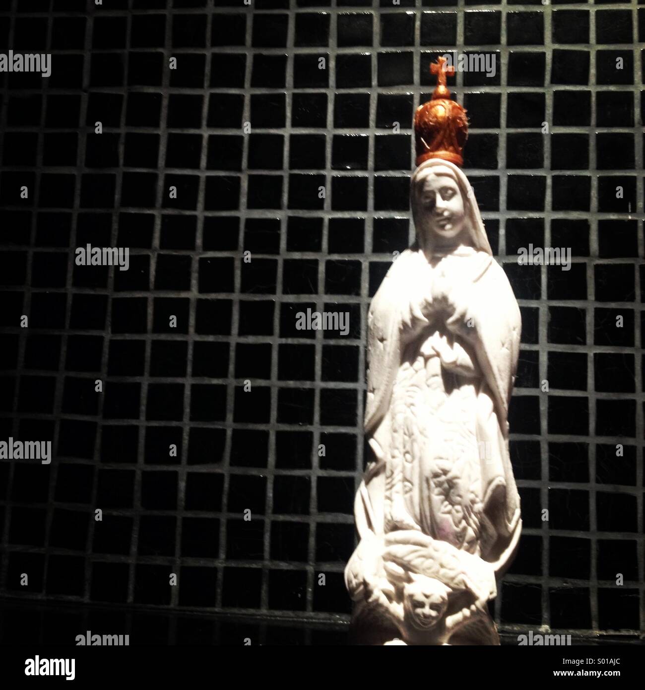 An image of a white Virgin of Guadalupe decorates a house in Mexico City, Mexico - Smartphone Captured Stock Image