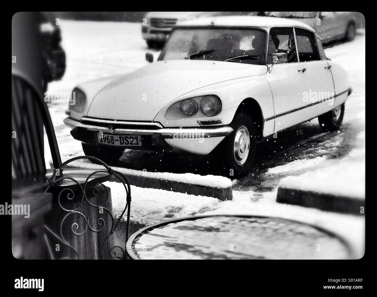 1968 French Citroen DS21 outside a cafe window on a snowy day. Stock Photo