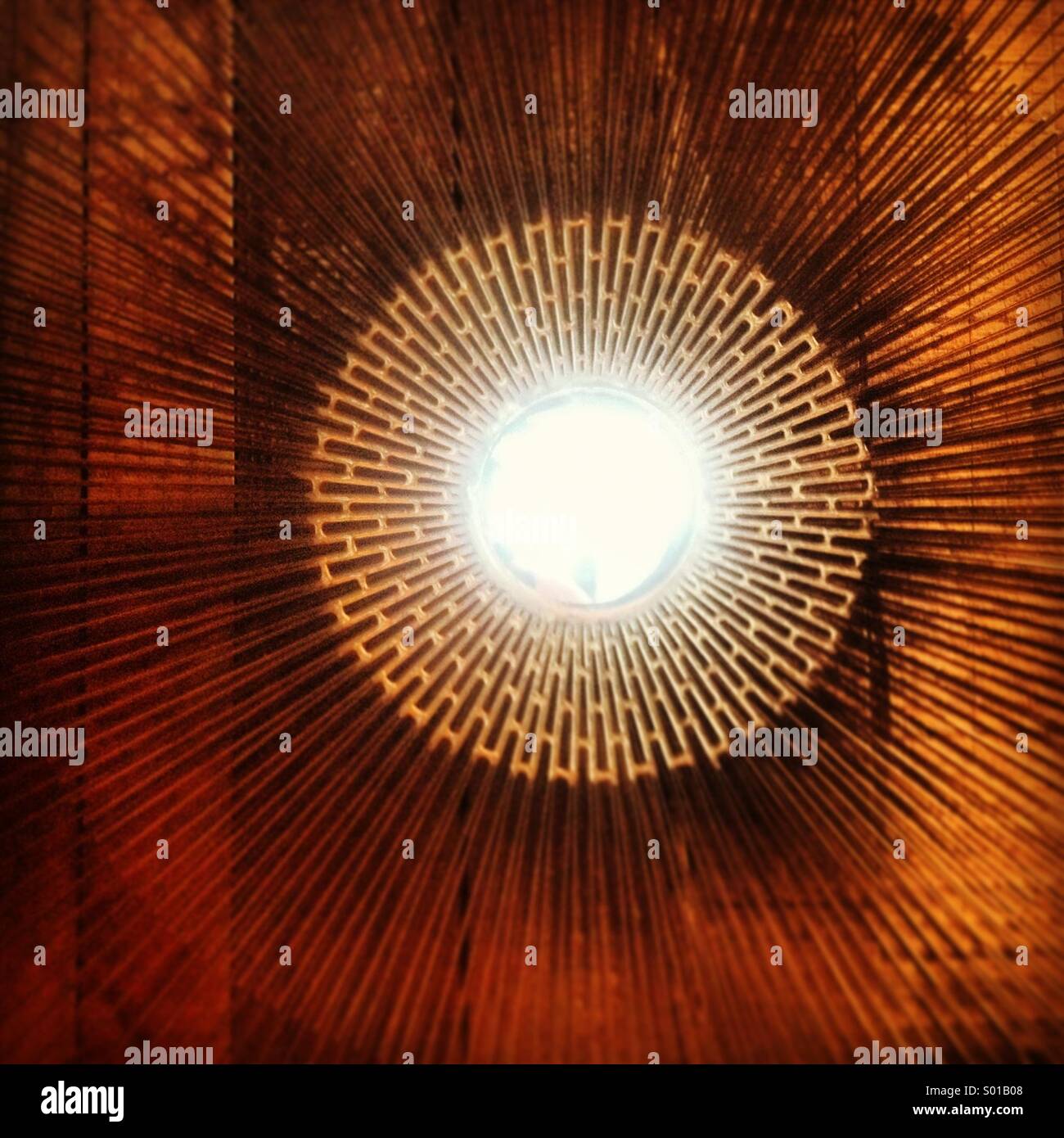 Sunlight reflects in a mirror surrounded by geometric patterns in a restaurant in Colonia Roma, Mexico City, Mexico - Smartphone Captured Stock Image