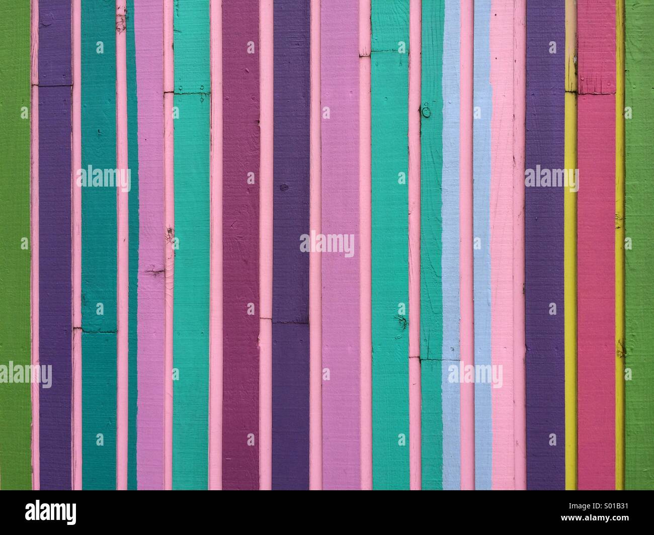 Multi colored pieces of wood on the side of a modern building. Stock Photo