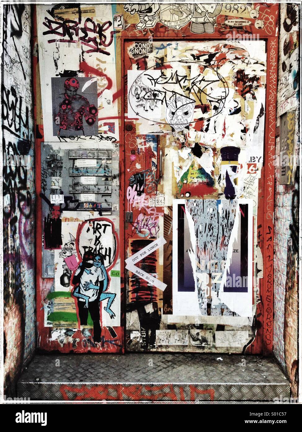 Entry door covered in graffiti and stickers,Shoreditch,London - Smartphone Captured Stock Image