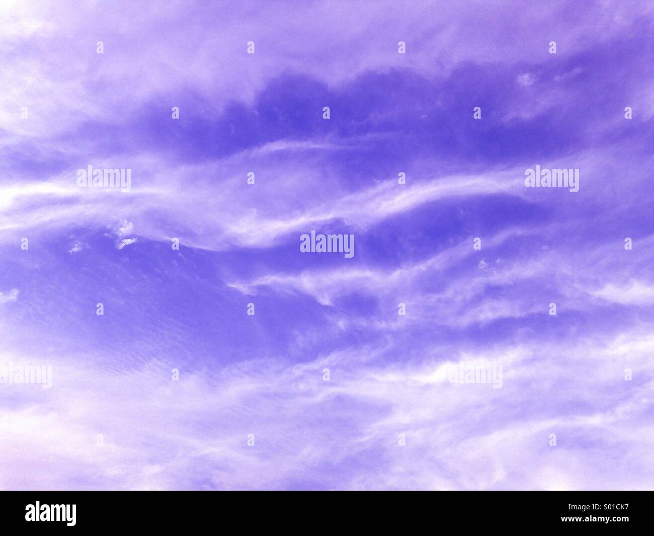 Complex white clouds in a purple sky. - Smartphone Captured Stock Image