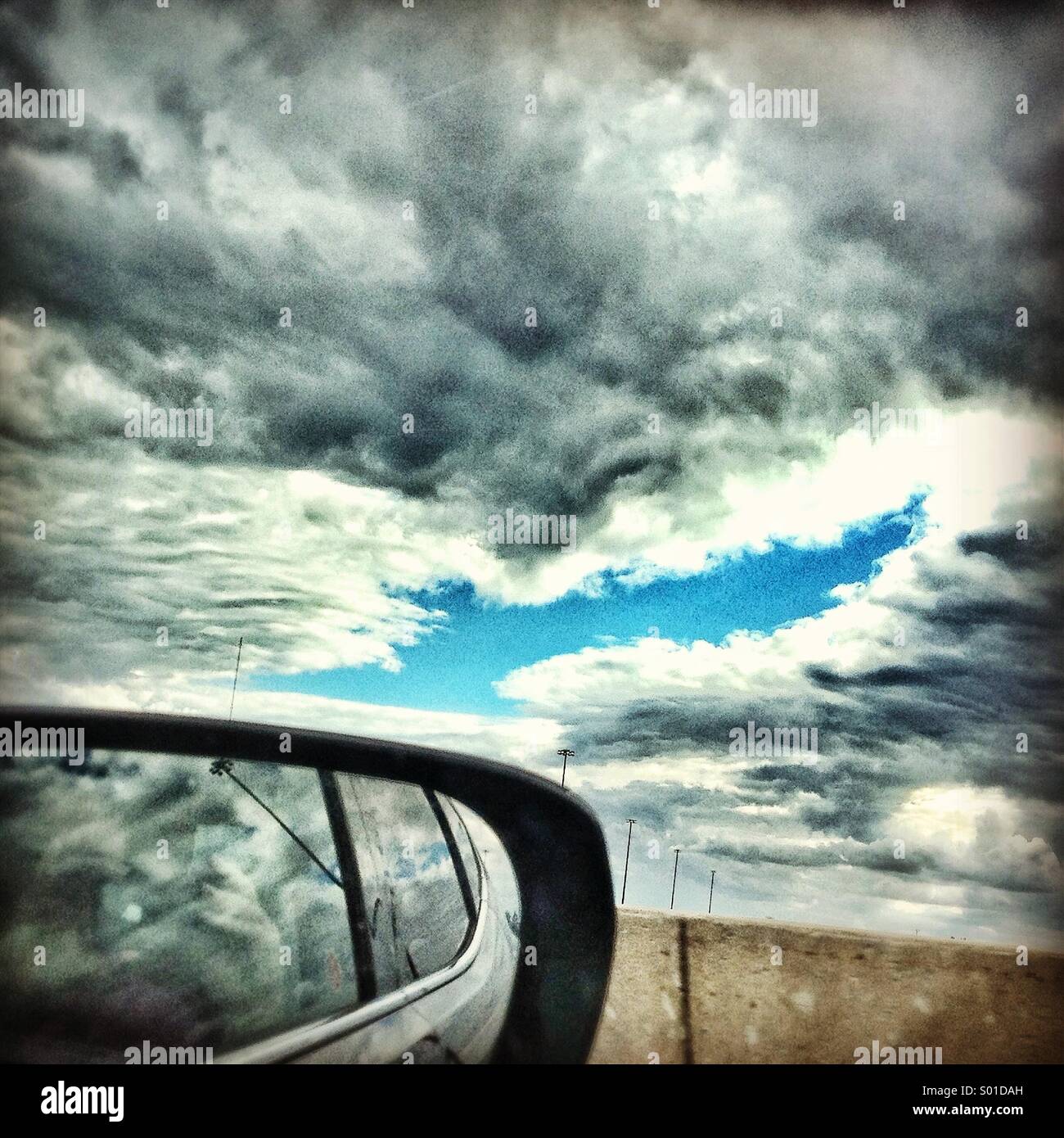 Looking out car window to break in clouds ahead - Smartphone Captured Stock Image