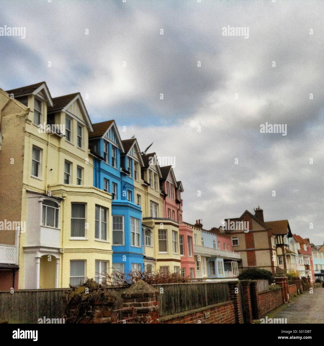 Brightly coloured houses on Aldeburgh seafront, with a stormy sky above. - Smartphone Captured Stock Image