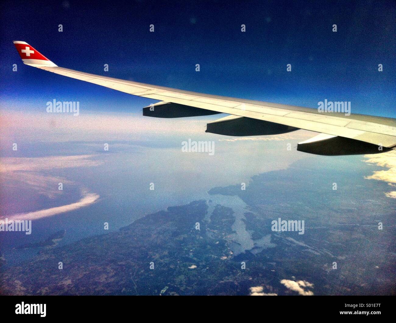 Approaching JFK - the wing of a Swiss aircraft over the east coast of the United States - Smartphone Captured Stock Image