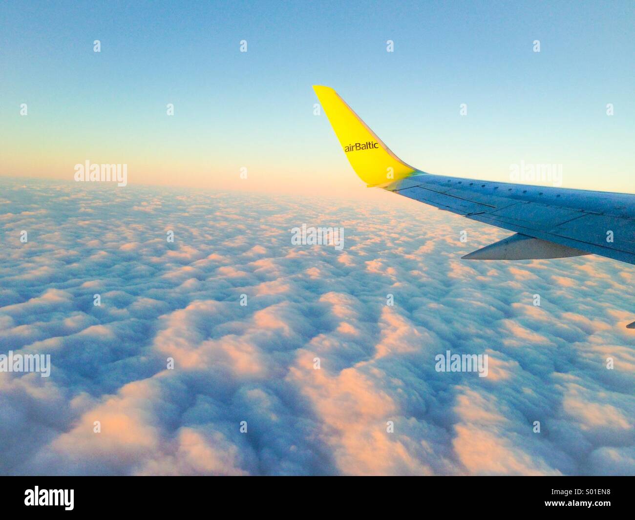 Airbaltic airplane up above the clouds Stock Photo