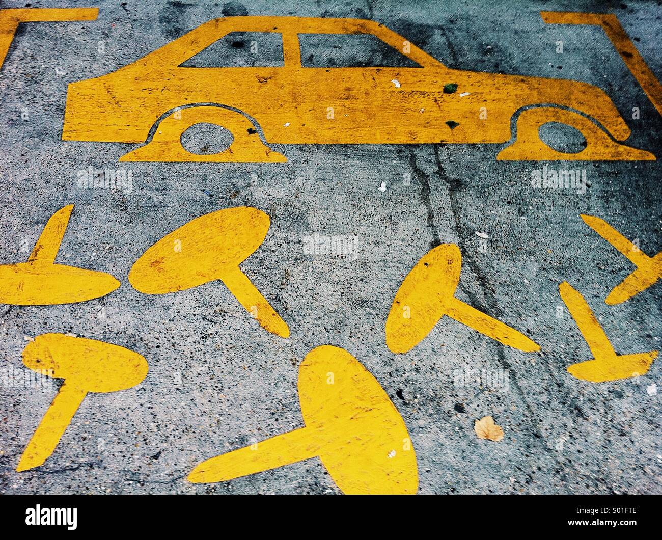 Street art on a pavement depicting a car with flat tyres and lots of falling drawing pins. Stock Photo