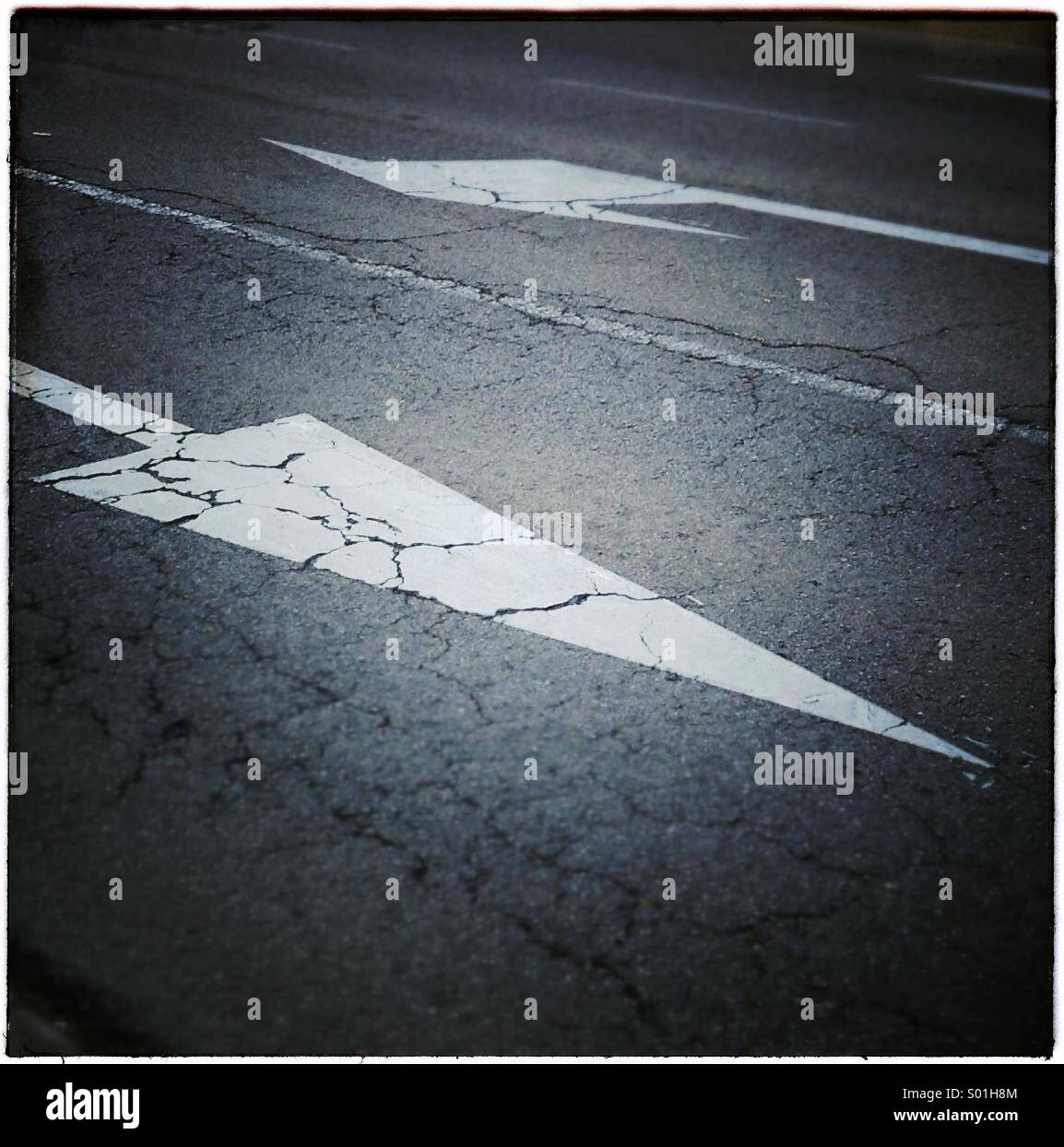Arrows on road asphalt. Two directions concept Stock Photo