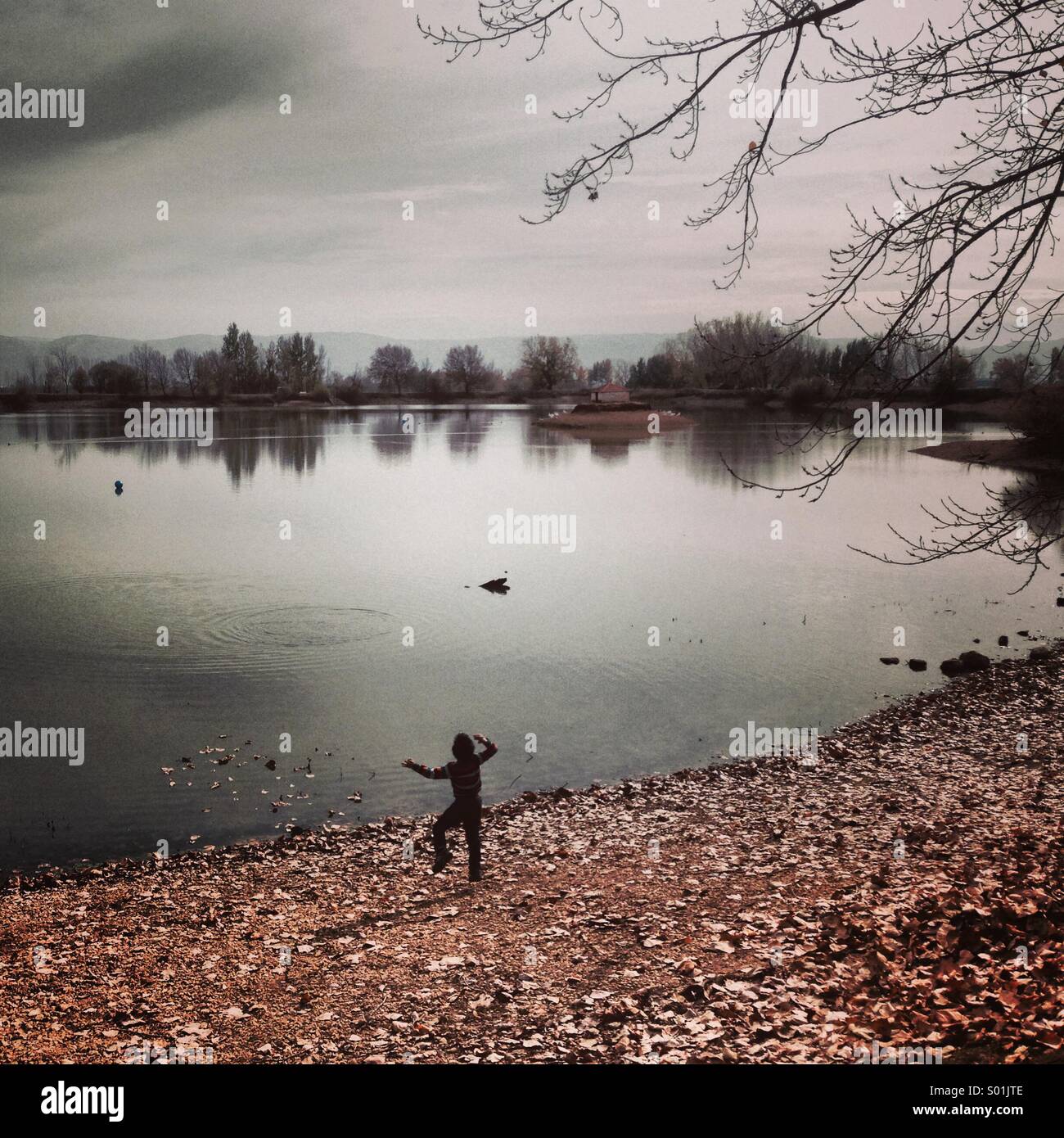 Happy Kid playing at the lake in the beautiful nature - Lebanon Middle East - Smartphone Captured Stock Image