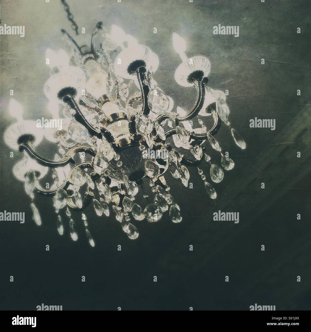 Crystal chandelier light fixture in old mansion. - Smartphone Captured Stock Image