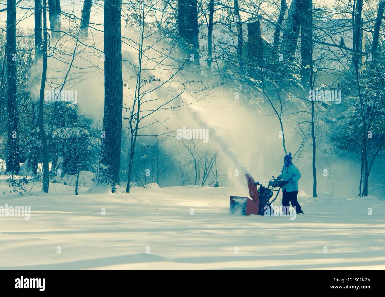 Clearing the driveway with a snowblower Stock Photo Alamy