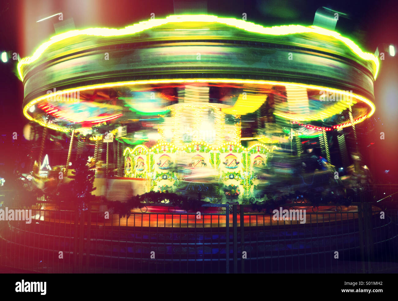 Fairground Carousel Lit Up At Night With Motion Blur Stock Photo Alamy