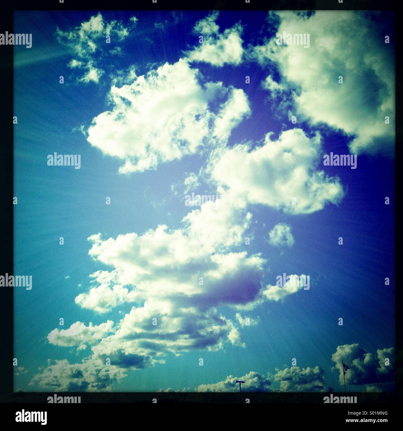White puffy clouds in the summer sky. Stock Photo